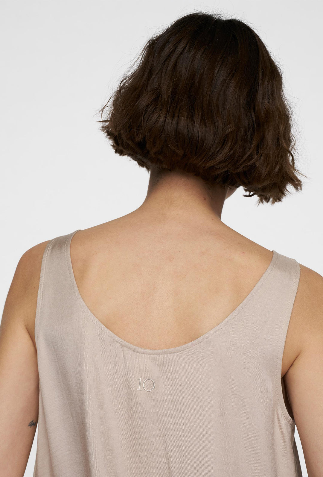 Minimalistyczny top na szerokich ramiączkach w beżowym kolorze
