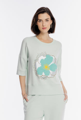 Mętowa bluza z krótkim rękawem i kwiatową aplikacją