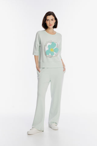 Miętowy dresowy komplet z aplikacją dużego kwiatu